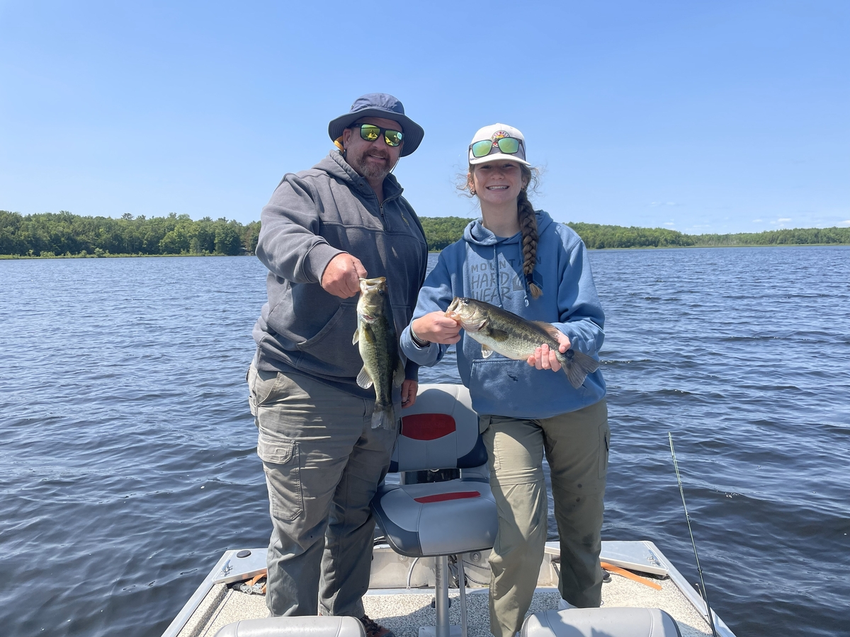 “Anglers on guided open water fishing trip in Maine targeting bass and brook trout